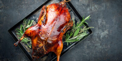 Traditional,Roasted,Stuffed,Christmas,Peking,Duck,With,Herbs,As,Top